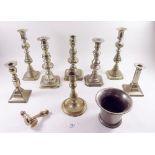 Various brass candlesticks and a pestle and mortar