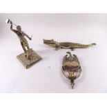 A brass eagle door knocker, brass crocodile and a brass blacksmith