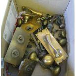 A  box of brass door handles, light switch etc.