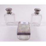 Two cut glass silver topped toiletry bottles and a dressing table box