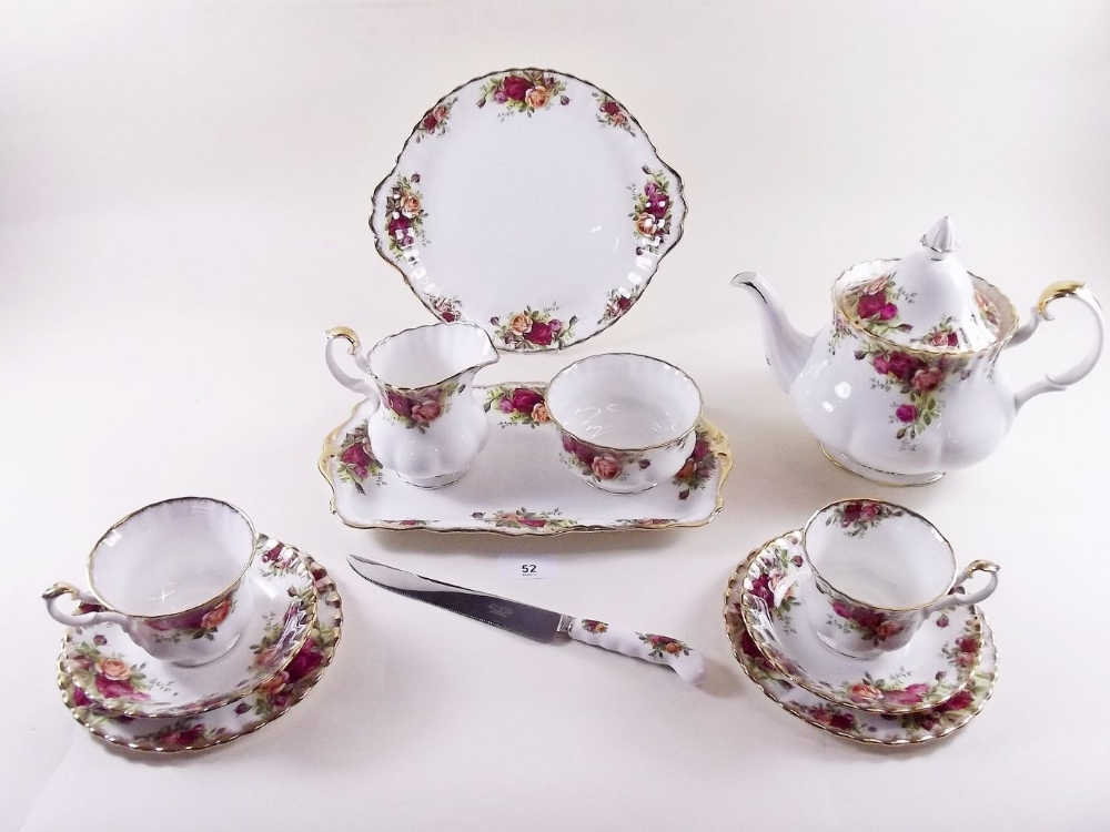 A Royal Albert Country Roses teaset comprising: teapot, six cups and saucers, milk, sugar, cake