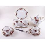 A Royal Albert Country Roses teaset comprising: teapot, six cups and saucers, milk, sugar, cake