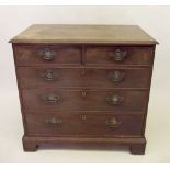 A George III mahogany chest of two short and three long drawers on bracket feet