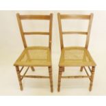 A pair of Edwardian cane seated lightwood bedroom chairs