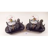 Two oriental novelty mantel clocks with cat watching moving fish in a glass bowl