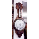 A late Victorian carved oak aneroid barometer/thermometer