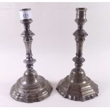 Two old silvered brass candlesticks