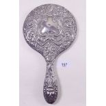A silver embossed hand mirror