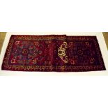 A Persian red ground runner with stylised bird and flower decoration - 315 x 96cm