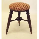 A Victorian circular piano stool on adjustable reeded supports