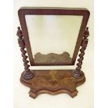 A Victorian mahogany swing mirror on spiral supports