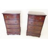 A pair of reproduction mahogany bedside cabinets of four drawers