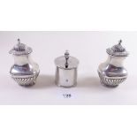 A pair of silver half gadrooned pepper pots and a silver mustard pot with blue glass liner