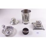 A box of silver and plate, including two inkwells, German beaker, wine taster and napkin ring