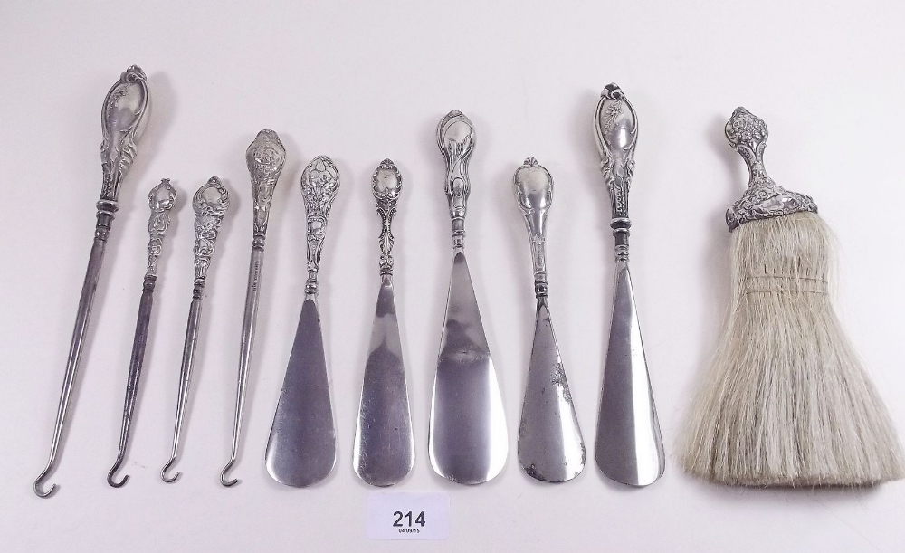 A quantity of silver handled shoe horns, button hooks and brush