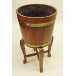 An oak brass bound barrel form jardiniere