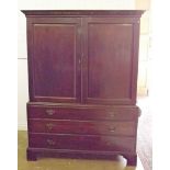 A Victorian mahogany linen press with two panelled doors over three long drawers