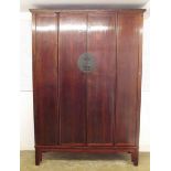 A late 19th/early 20th century large Chinese antique bookcase with four panelled doors enclosing