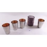 A set of four silver plated stirrup cups in leather case