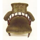 A Victorian tub chair with button upholstered and spindle back