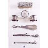 A group of silver to include: brush, salt, napkin rings etc.