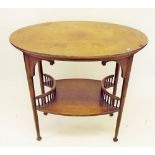 An Edwardian mahogany oval occasional table with spindle undertier