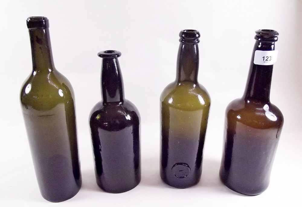 Four antique brown bottles with inverted dome bases