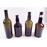 Four antique brown bottles with inverted dome bases