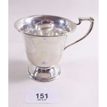 A small silver cup on pedestal base