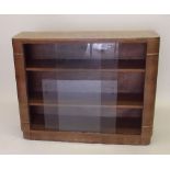 A walnut Art Deco bookcase with glass sliding doors