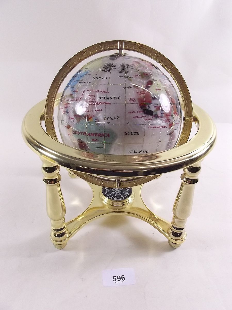 A mother of pearl globe on stand