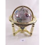 A mother of pearl globe on stand