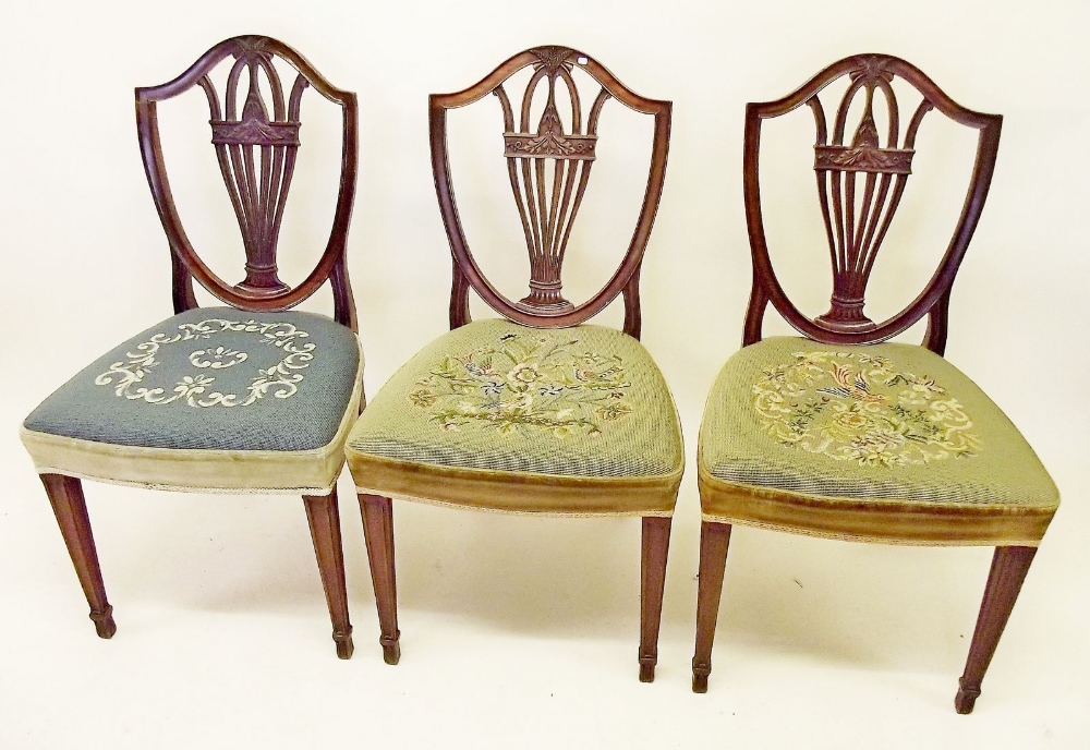 Three mahogany Hepplewhite style shield back dining chairs