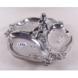 A silver plated entree dish with cherub blowing horn to centre and vine borders