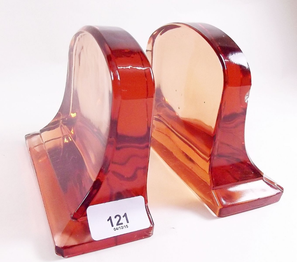 A pair of Art Deco peach glass bookends