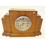 A ships clock mounted in 1930's Art Deco style case and key