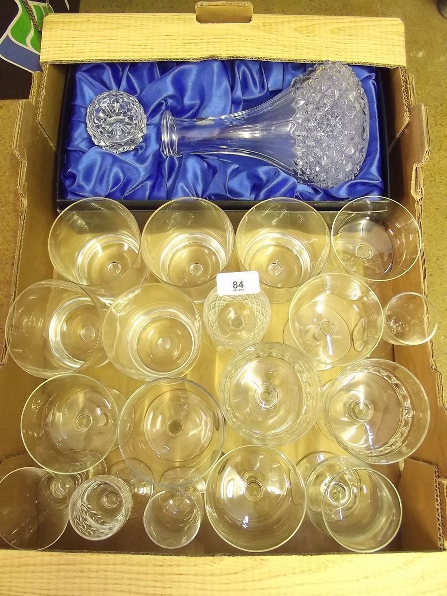 A box of drinking glasses and a decanter