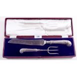 A cased silver handled cake serving knife and fork