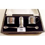 A three piece silver cruet set with spoons and liners - boxed