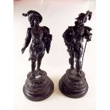 A pair of black painted spelter figures of cavaliers - 51cm high