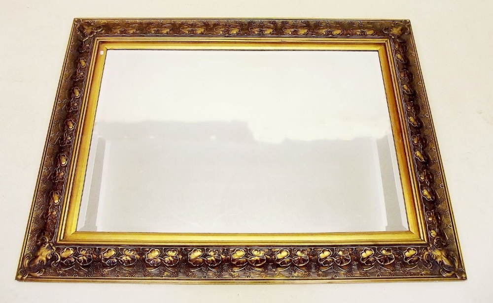 A large foliage moulded gilt framed mirror - 116 x 86cm