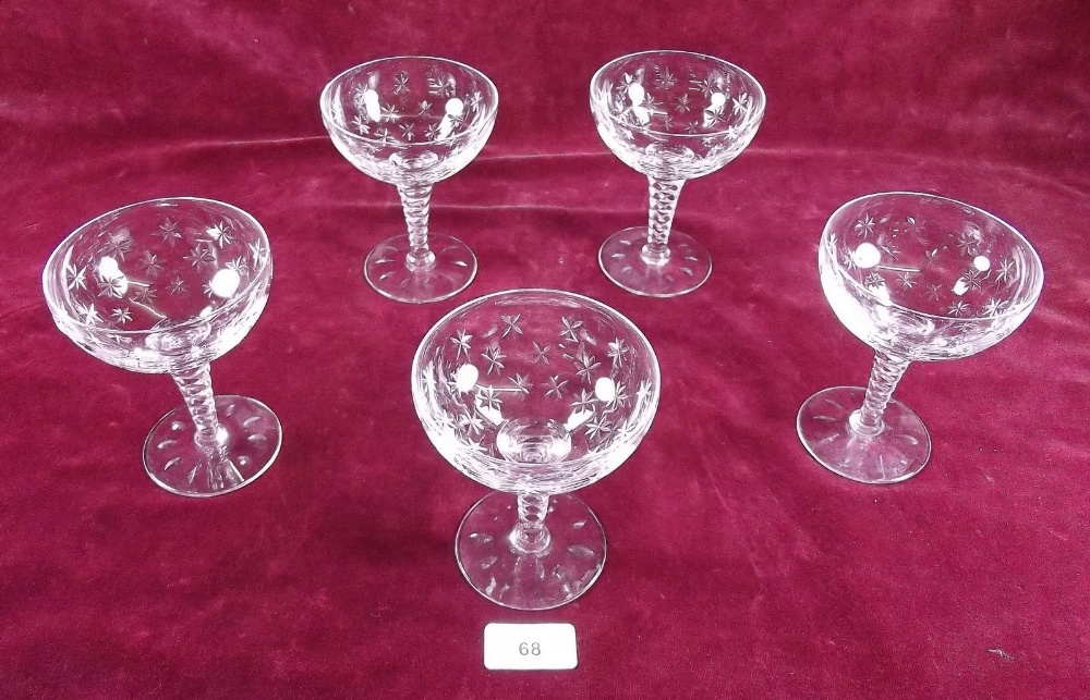 A set of five cut glass champagne glasses