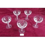 A set of five cut glass champagne glasses