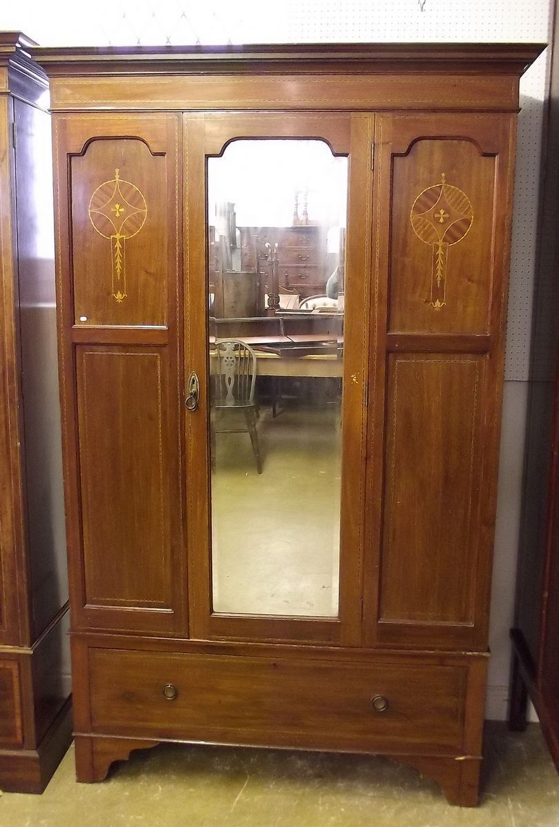 An Edwardian mahogany inlaid single door wardrobe with marquetry inlay