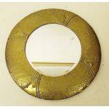 A circular brass framed mirror