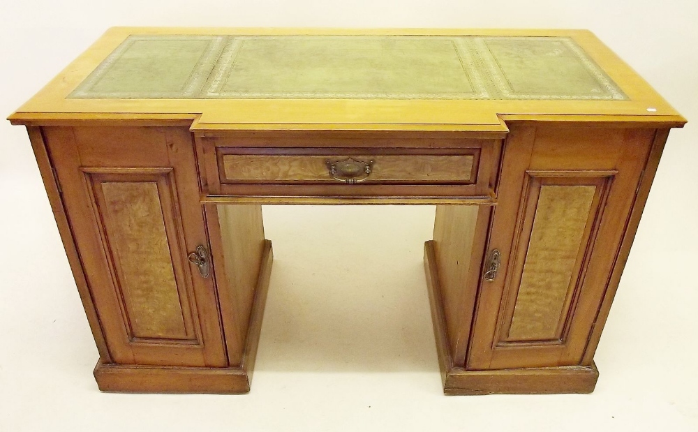 An early 20th century yew twin pedestal desk with later inset leather top