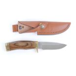 Sheath knife with 4 ins single edge blade stamped Buck 192 USA with brass mounts, wood grips,
