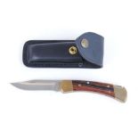 Clasp knife with 4 ins lock blade stamped Buck 110 USA, brass mounts, Rosewood grips, leather pouch