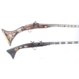 Two Indian decorative tribal muskets with ornately bound barrels, snaphaunce actions and inlaid