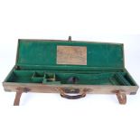 Canvas and leather gun case with brass corners, fitted interior for 30 ins barrels and with